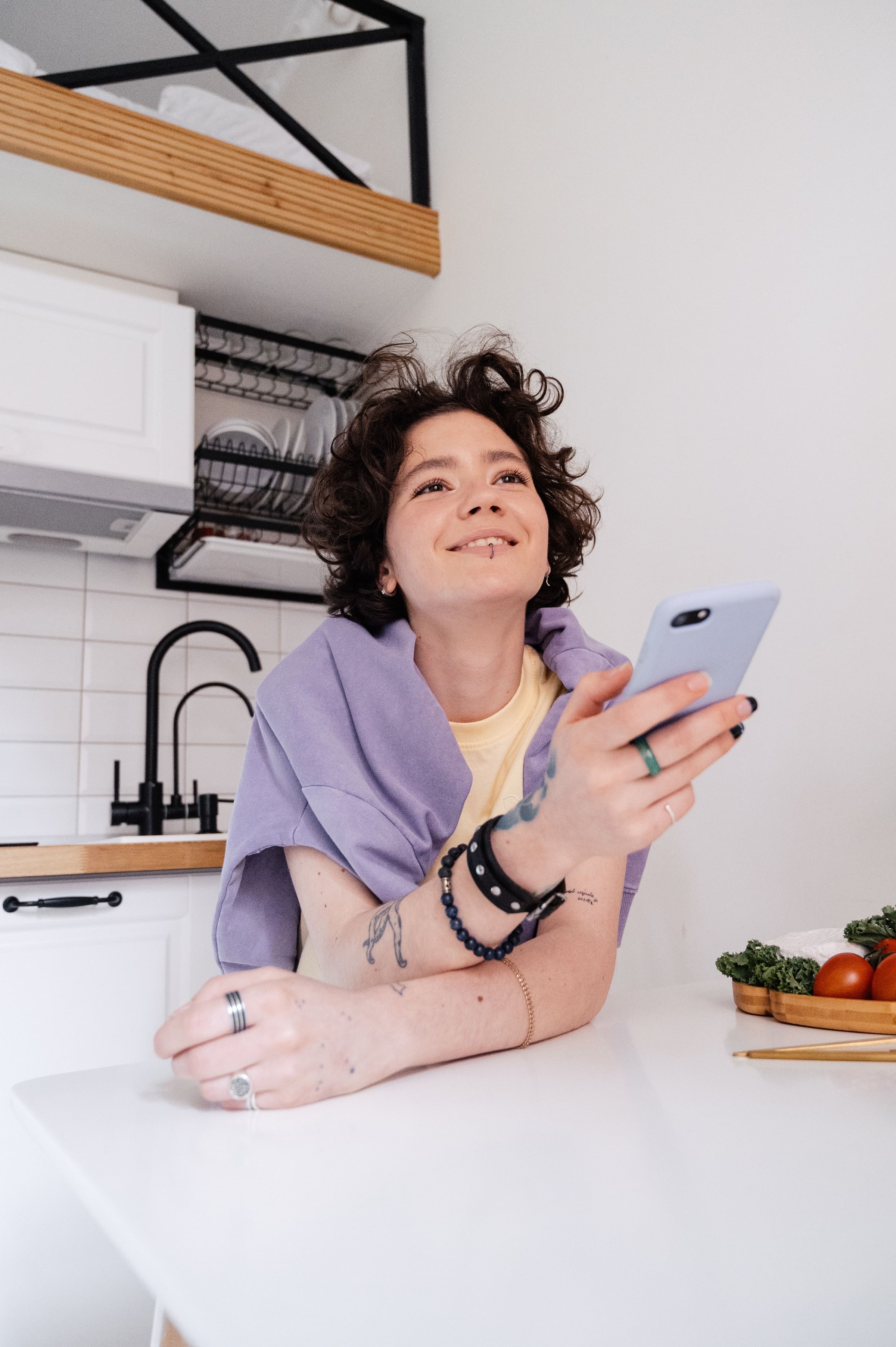 Une femme consulte l'application dans sa cuisine